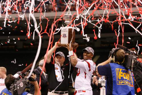Utah head coach Kyle Whittingham  and Utah quarterback Brian Johnson (3) hold their trophy aloft after the Utes defeated Alabama in the 75th annual Sugar Bowl in New Orleans, Friday, January 2, 2009.

Scott Sommerdorf/The Salt Lake Tribune