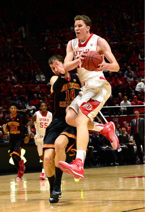 Scott Sommerdorf   |  The Salt Lake Tribune
Utah Utes forward Jakob Poeltl (42) runs into USC Trojans forward Strahinja Gavrilovic (14) as he drove on a fast break during first half play. Gavrilovic was called for a foul. Utah held a 39-22 lead over the USC Trojans at the half, Friday, January 2, 2015.