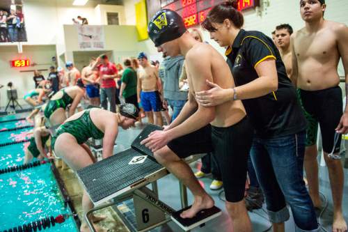 Chris Detrick  |  The Salt Lake Tribune
Assistant coach Abi Schofield helps sophomore Kale Walker onto the starting block before competing in the 50 freestyle race at Wasatch High School Swimming Pool Thursday January 15, 2015.  Walker has been blind since birth and this is his first year on the Wasatch swim team.