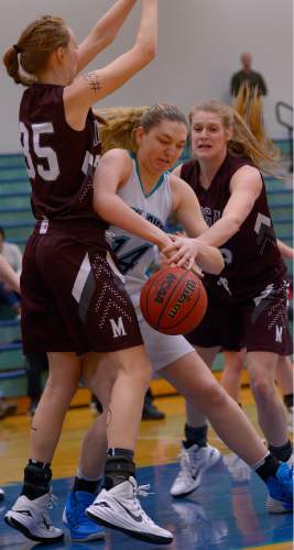 Leah Hogsten  |  The Salt Lake Tribune
Morgan's Lily Henry and Madi Pace keep Juan Diego's Ann Nelson out of the lane.  Juan Diego High School girls basketball team leads Morgan High School 32-27 at the half, Friday, January 16, 2015.