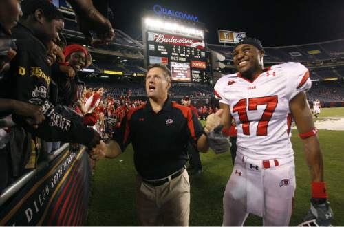 UTAH @ SAN DIEGO STATE
Utah head coach Kyle Whittingham clebrates the big win with the family of his DB Robert Johnson (right) after Utah defeats San Diego State 63-14.
Scott Sommerdorf / The Salt Lake Tribune