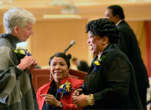 Al Hartmann  |  The Salt Lake Tribune
Carlie Christensen, Acting United States Attorney District of Utah, left, is greeted by Jeanetta Williams, President of NAACP Salt Lake Branch, right.  In center is  keynote speaker Nicole Francis, program manager for Smart Global Solutions and NASA Research and Education Support Services.  The NAACP helds its 31st annual Dr. Martin Luther King Jr., Memorial luncheon at Little America in Salt Lake City Monday January 19.