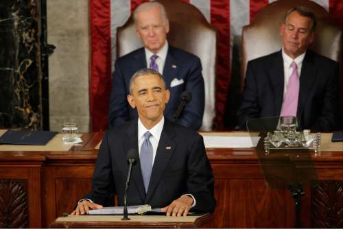 President Barack Obama pauses during his State of the Union address before a joint session of Congress on Capitol Hill in Washington, Tuesday, Jan. 20, 2015. Vice President Joe Biden and House Speaker John Boehner of Ohio listen.  (AP Photo/J. Scott Applewhite)