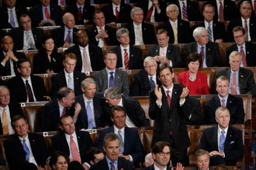Rep. Martin Heinrich, D-N.M., appluds while siiting with Republican members of Congrss during Presient Barack Obama's State of the Union address before a joint session of Congress on Capitol Hill in Washington, Tuesday, Jan. 20, 2015 (AP Photo/Pablo Martinez Monsivais)