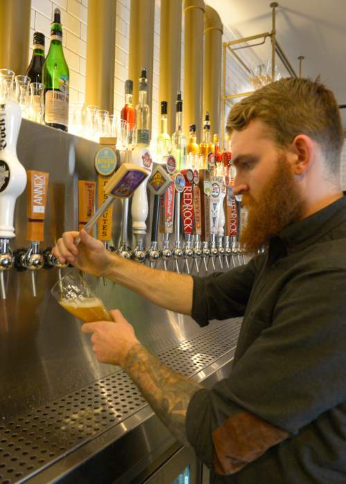 Rick Egan  |  The Salt Lake Tribune

Kyle Trammell pours a beer at the Beer Bar, 155 E. 200 South in Salt Lake, Wednesday, March 26, 2014