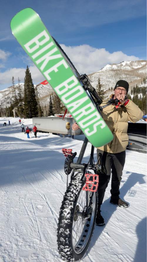 Al Hartmann  |  The Salt Lake Tribune
Brian Hannon, an exhibitor with Bikeboards LLC, shows a Bike Board attached to a fat-tire bike at the Winter Market Outdoor Retailers at Solitude Mountain Resort for the All Mountain Demo Tuesday January 20, 2015. It's a short ski with brackets that attach to a bike allowing it to be ridden in snow. The company is out of Montrose, Colo. The demo day gives retailers the opportunity to test gear in the environment it was made for to make informed buying decisions.