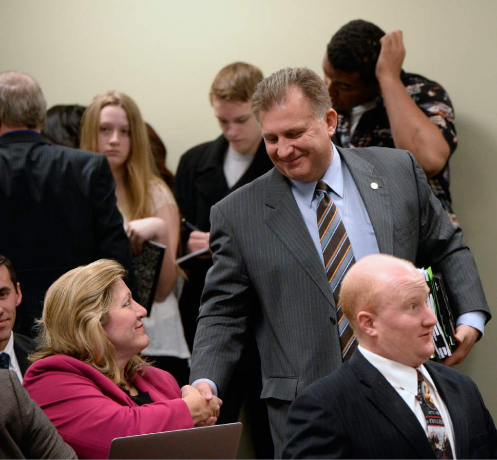 Al Hartmann  |  The Salt Lake Tribune 
Senator Curtis Bramble sponsor of SB005401, Elections Amendments gets a congrautalations handshake from former legislator Holly Richardson and republican politcal blogger in the audience at the House Government Operation Standing Committee Monday March 3   The amended bill passed unananimously in the committee to bring it to the house floor.  Many on the committee had reservations but voted for the so-called "Utah count my vote" compromise bill.