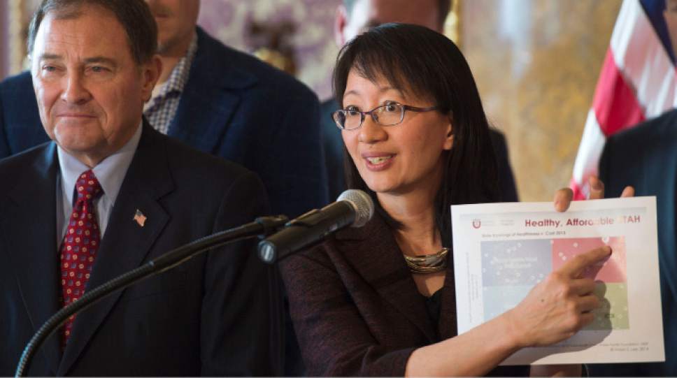 Steve Griffin  |  The Salt Lake Tribune

Holding a graph showing Utah as having the best health and most affordable health care in the country, University of Utah Senior VP for Health Sciences, Vivian Lee, joins Gov. Gary Herbert as he releases his detailed Healthy Utah plan, which is an alternative way to expanding health care coverage for the poor without technically expanding Medicaid. The plan was hammered out in months of negotiation this year with the U.S. Department of Health and Human Services. He was joined in the Gold Room at the Utah State Capitol by city and state leaders in Salt Lake City, Thursday, December 4, 2014. Date for the graph comes from the Kaiser family Foundation which is a non-profit organization focusing on national health issues, as well as the U.S. role in global health policy.