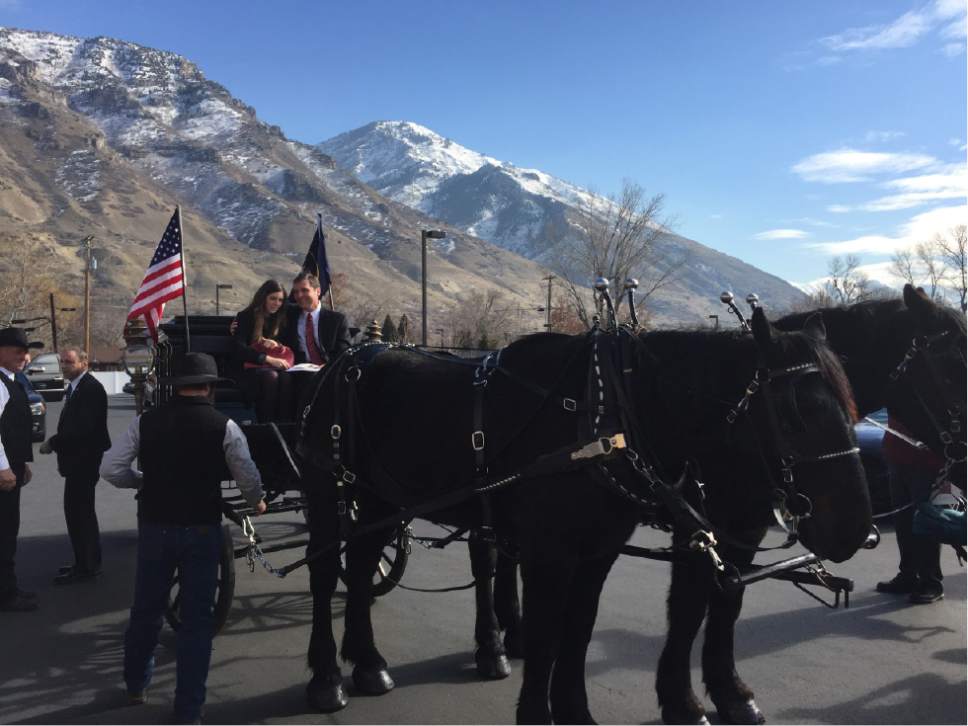 Matt Canham  |  The Salt Lake Tribune 

Stan Lockhart and his daughter Hannah ride on the horse-drawn carriage carrying the body of Becky Lockhart, Utah's former House Speaker. She was buried in a Provo cemetery on Friday.