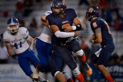 Scott Sommerdorf  |  The Salt Lake Tribune
Brighton RB Osa Masina runs the ball early as Brighton hosted rival Bingham in a 5A game played Friday, September 26, 2014.