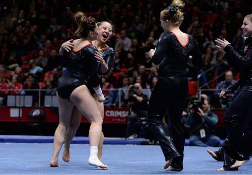 Scott Sommerdorf   |  The Salt Lake Tribune
Corrie Lathrop, second from left, celebrates her floor routine with team mates. Utah Gymnastics defeated UCLA 196.725 - 194.725 in the Huntsman Center, Friday, January 23, 2015.