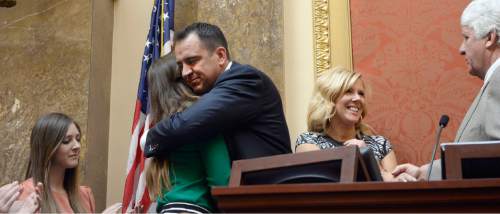 Al Hartmann  |  The Salt Lake Tribune
Greg Hughes, new speaker of the Utah House of Representatives, hugs the daughters of former Speaker Becky Lockhart who recently passed away.  Hughes just finished taking the oath of office to start the 2015 legislative session Monday Jan 26.  Hughes' wife Krista, and Congressman Rob Bishop, are at  right.