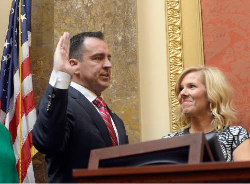 Al Hartmann  |  The Salt Lake Tribune
Greg Hughes takes the oath of office to become the next speaker of the Utah House of Representatives at the start of the 2015 legislative session Monday Jan 26.  His wife Krista is at right.