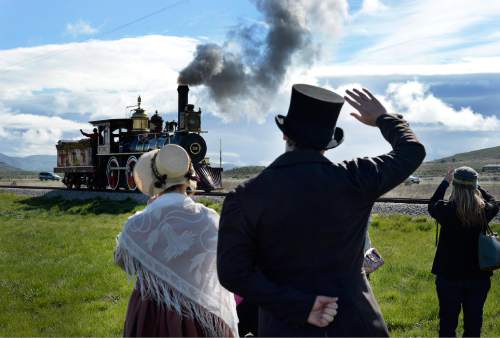 Scott Sommerdorf   |  The Salt Lake Tribune
Actors in period costumes greet one of the locomotives used in the Golden Spike re-enactment ceremony. The Chinese community honored Chinese immigrants who built the railroad from the west by taking more than three busloads of people to the Golden Spike National Monument for the 145th commemoration of the completion of the transcontinental railroad on  Saturday.