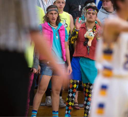 Steve Griffin  |  The Salt Lake Tribune

Taylorsville fans dressed in 1970's throwback gear cheer their team on during game against Hunter at Taylorsville High School in Taylorsville, Tuesday, January 27, 2015.