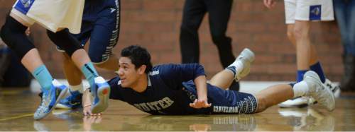 Steve Griffin  |  The Salt Lake Tribune

Hunter's Noah Togiai dives to the floor after a loose ball during game between Taylorsville and Hunter at Taylorsville High School in Taylorsville, Tuesday, January 27, 2015.