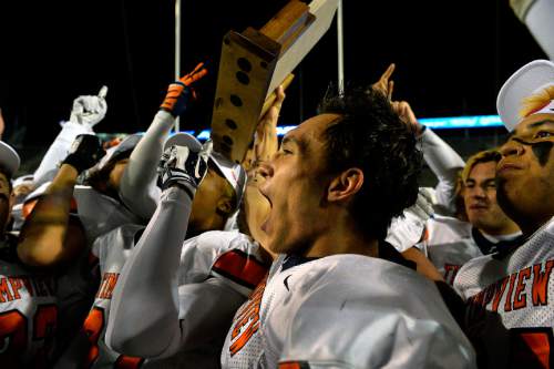 Chris Detrick  |  The Salt Lake Tribune
Timpview's Britain Covey (2) holds up the trophy as his teammates celebrate after winning the 4A state championship game at Rice-Eccles Stadium Friday November 21, 2014.