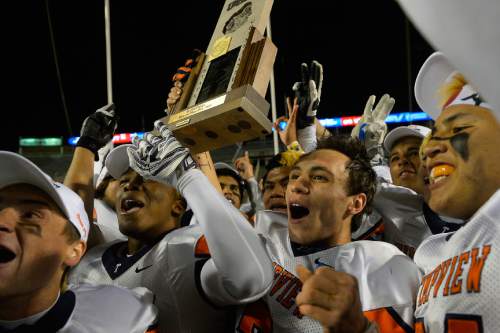 Chris Detrick  |  The Salt Lake Tribune
Timpview's Britain Covey (2) holds up the trophy as his teammates celebrate after winning the 4A state championship game at Rice-Eccles Stadium Friday November 21, 2014.