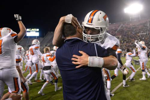 Chris Detrick  |  The Salt Lake Tribune
Timpview's Britain Covey (2) hugs head coach Cary Whittingham after winning the 4A state championship game at Rice-Eccles Stadium Friday November 21, 2014.