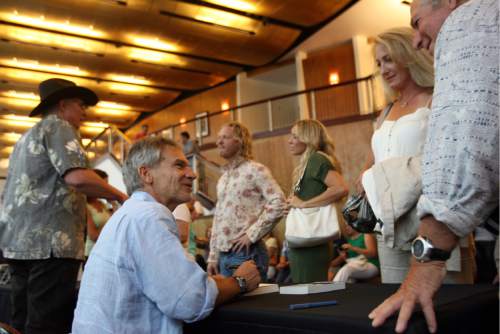 Kim Raff | The Salt Lake Tribune
Jon Krakauer signs books for (right) Rick Luskin and Loree DeYoung before he participated in a Utah Film Center panel discussion about adapting investigations into extreme religious groups into documentaries and dramatic fiction films at the Rose Wagner Performing Arts Center in Salt Lake City, Utah on August 5, 2012.