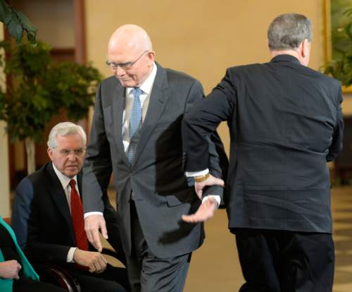 Al Hartmann  |  The Salt Lake Tribune
LDS Apostles Dallin H. Oaks, center, shakes hand with Apostle Jeffrey R. Holland as he walks to the microphone to make a public statement of religious freedom and nondiscrimination in Salt Lake City Tuesday Jan. 27, 2015.  Apostle D. Todd Christofferson, is sitting at left.   The leaders called for legislation that protects vital religious freedoms while at the same time supporting protections in housing and employment for LGBT people.