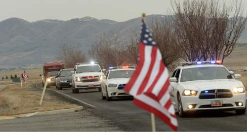 Al Hartmann  |  The Salt Lake Tribune
NProcession of law enforcement and fire vehicles form procession along Pony Express Parkway in Eagle Mountain to First Anniversary Memorial Event and Park Dedication for Utah County Sheriff Sgt. Cory Wride, who was fatally shot in the line of duty on Jan. 30, 2014.   
Eagle Mountain City renamed Mid-Valley Regional Park as Cory B. Wride Memorial Park so that Sgt. Wride's service and sacrifice will always be remembered.