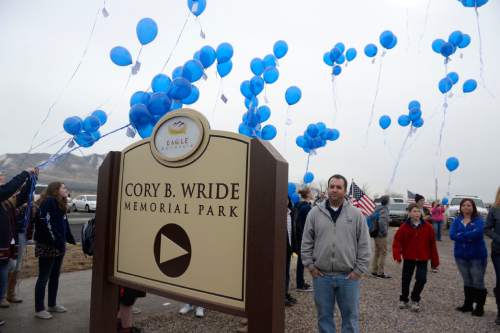Al Hartmann  |  The Salt Lake Tribune
Students from Frontier Middle School release blue balloons to honor Cory Wride at First Anniversary Memorial Event and Park Dedication for Utah County Sheriff's Sgt. Cory Wride, who was fatally shot in the line of duty on Jan. 30, 2014.  The blue balloons were released as a final salute to Wride. 
Eagle Mountain City renamed Mid-Valley Regional Park as Cory B. Wride Memorial Park so that Sgt. Wride's service and sacrifice will always be remembered.