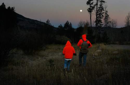 Scott Sommerdorf   |  The Salt Lake Tribune
Twelve year old Grayden Larson and his father Aaron of Bluffdale head out on their first hunting trip together as they hunt near Soapstone Basin just off the Mirror Lake Highway, early Saturday morning, October 19, 2013.