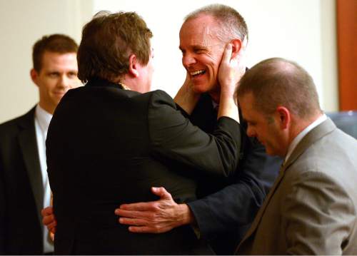 Leah Hogsten  |  Tribune file photo
Marc Sessions Jenson hugs his defense co-counsel Helen Redd after he was found not guilty Friday, January 30, 2015 of fraud and money laundering in connection with the failed Mount Holly golf and ski resort near Beaver -- a case with ties to the bribery and corruption investigation of former Utah attorneys general Mark Shurtleff and John Swallow. Following a three-week trial, a jury of five men and three women deliberated 14 hours over two days before acquitting Jenson of four counts each of second-degree felony communications fraud and money laundering.