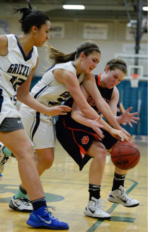 Francisco Kjolseth  |  The Salt Lake Tribune 
Mikelle Magalogo of Copper Hills, center, and Brighton's Lindsey Johnson try to regain control of the ball in the class 5A game as the No. 2-ranked teams battle it out at Copper Hills in West Jordan on Thursday night, Jan. 29, 2015.