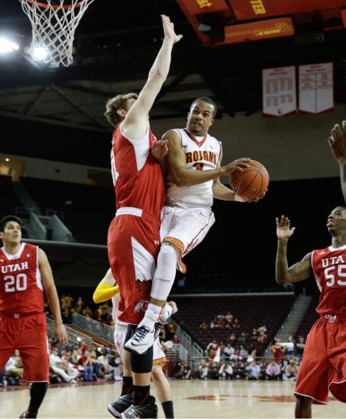 Southern California's Chass Bryan, right, is defended by Utah's Dallin Bachynski during the second half of an NCAA college basketball game, Sunday, Feb. 1, 2015, in Los Angeles. Utah won 67-39. (AP Photo/Jae C. Hong)
