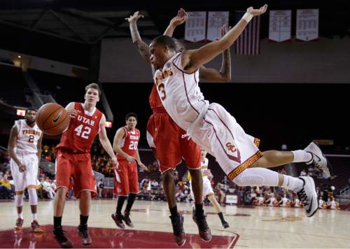 Southern California's Chass Bryan, front, is fouled by Utah's Delon Wright during the second half of an NCAA college basketball game, Sunday, Feb. 1, 2015, in Los Angeles. Utah won 67-39. (AP Photo/Jae C. Hong)