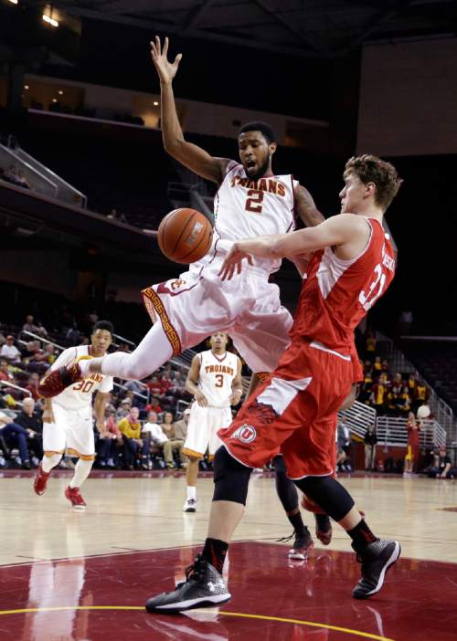 Southern California's Malik Martin, left, is defended by Utah's Dallin Bachynski during the second half of an NCAA college basketball game, Sunday, Feb. 1, 2015, in Los Angeles. Utah won 67-39. (AP Photo/Jae C. Hong)