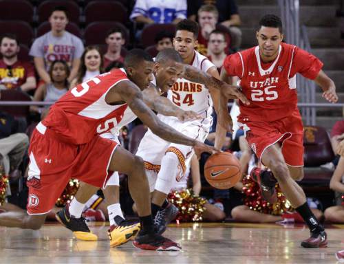 Utah's Delon Wright, left, and Southern California's Darion Clark go after a loose ball during the first half of an NCAA college basketball game, Sunday, Feb. 1, 2015, in Los Angeles. (AP Photo/Jae C. Hong)