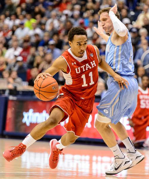 Trent Nelson  |  The Salt Lake Tribune
Utah Utes guard Brandon Taylor (11) drives around Brigham Young Cougars guard Skyler Halford (23) as BYU hosts Utah, college basketball at the Marriott Center in Provo, Wednesday December 10, 2014.