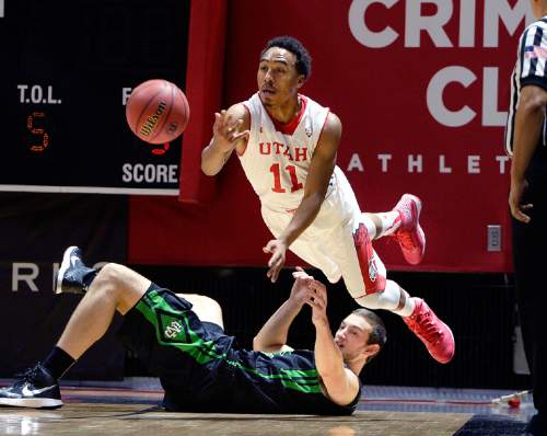 Utah guard Brandon Taylor (11) leaps to pass the ball after a steal on the North Dakota baseline against North Dakota forward Chad Calcaterra (33) during the first half on an NCAA college basketball game, Friday, Nov. 28, 2014 in Salt Lake City. (AP Photo/The Salt Lake Tribune, Scott Sommerdorf)  DESERET NEWS OUT; LOCAL TELEVISION OUT; MAGS OUT