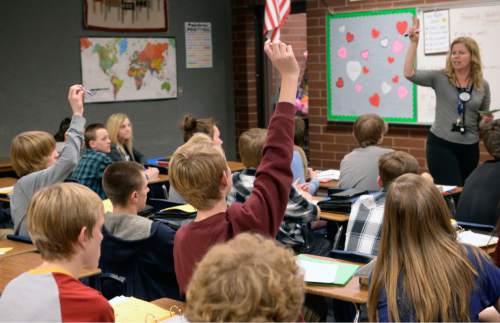 Al Hartmann  |  The Salt Lake Tribune
Students raise their hands in full classroom of 32 students in a Spanish class at South Jordan Middle School Monday Feb. 1.  Lawmakers will consider a proposal to raise taxes to fund schools, which could pay for technology, teacher salaries and relieve pressure on over crowding.