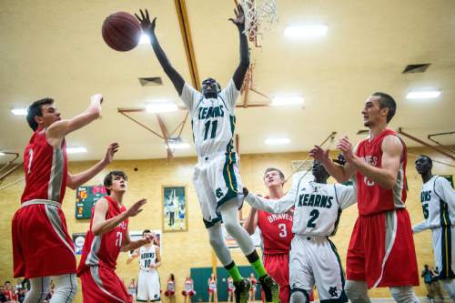 Chris Detrick  |  The Salt Lake Tribune
Kearns' Buay Kuajian (11) goes for a rebound during the game at Kearns High School Friday January 30, 2015.
