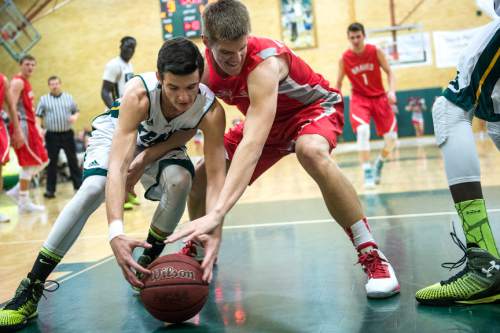 Chris Detrick  |  The Salt Lake Tribune
Kearns' Tayler Marteliz (10) and Bountiful's Collin Parrish (33) go for the ball during the game at Kearns High School Friday January 30, 2015.