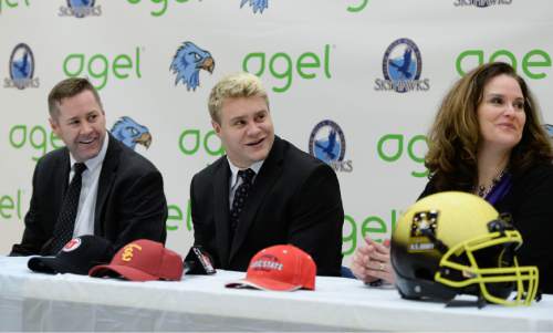 Francisco Kjolseth  |  The Salt Lake Tribune 
Salem Hills quarterback/linebacker Porter Gustin, one of the most highly touted prep football prospects in recent memory, is joined by his parents John and Scarlett Gustin moments before announcing his plans to attend USC during a school assembly on Tuesday, Feb. 3, 2015.