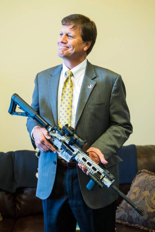 Chris Detrick  |  The Salt Lake Tribune
Rep. Keven J. Stratton (R-Orem) holds the 5th commemorative Legislative gun, an AR-15 5.56, in Rep. Curtis Oda's (R-Clearfield) office at the Utah State Capitol Tuesday February 3, 2015.