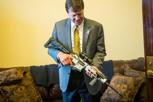 Chris Detrick  |  The Salt Lake Tribune
Rep. Keven J. Stratton (R-Orem) holds the 5th commemorative Legislative gun, an AR-15 5.56, in Rep. Curtis Oda's (R-Clearfield) office at the Utah State Capitol Tuesday February 3, 2015.