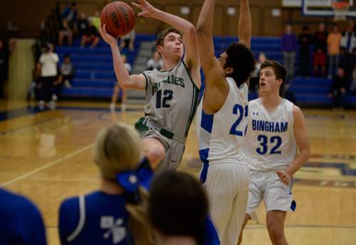 Scott Sommerdorf   |  The Salt Lake Tribune
Copper Hills' Stockton Shorts challenges Bingham's Yoeli Childs as he drives to the hoop during first-half play. Behind Shorts' clutch free throws down the stretch, Copper Hills upset Bingham on the road, Friday, February 6, 2015.