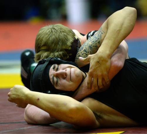 Steve Griffin  |  The Salt Lake Tribune

Maple Mountain's Kolton Jackson, back, clamps down on Roy's Robert Nunes during the 4A state wrestling tournament at UVU UCCU Arena in Provo, Wednesday, February 11, 2015.