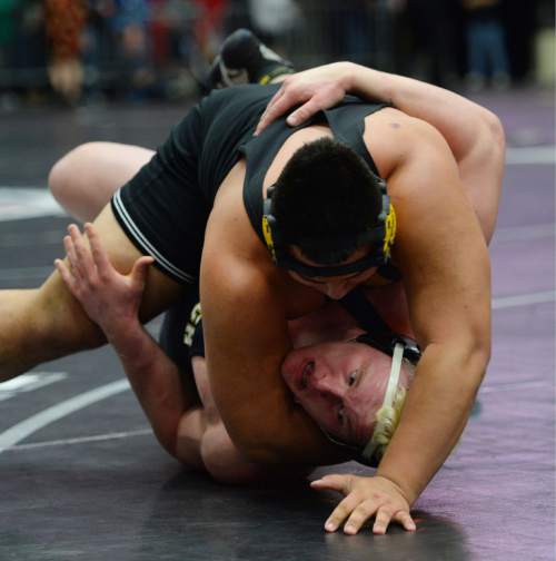 Steve Griffin  |  The Salt Lake Tribune

Murray's John Halaeua gets Ben Bos, of Wasatch on his back but can't control him as Bos spun out of the hold and pinned Halaeua  during the 4A state wrestling tournament at UVU UCCU Arena in Provo, Wednesday, February 11, 2015.
