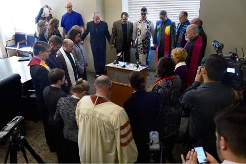 Scott Sommerdorf   |  The Salt Lake Tribune
A group of leaders from a range of religious faiths held hands in prayer after a press conference where they urged the legislature to pass SB 100 - Antidiscrimination Amendments, Thursday, February 12, 2015.