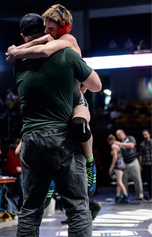 Trent Nelson  |  The Salt Lake Tribune
Bryce Brimhall of Syracuse celebrates victory by leaping into the arms of his coach after the 113 lb. 5A state championship wrestling match at Utah Valley University in Orem, Thursday February 12, 2015.