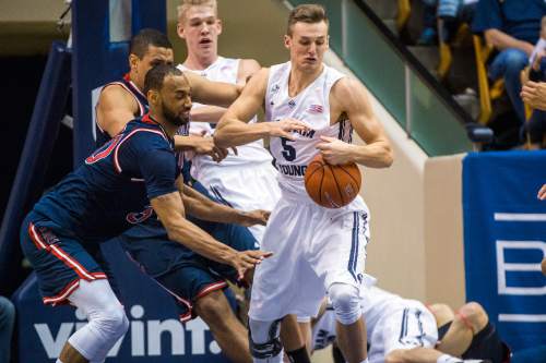 Chris Detrick  |  The Salt Lake Tribune
Brigham Young Cougars guard Kyle Collinsworth (5) grabs a rebound past St. Mary's Gaels forward Desmond Simmons (30) during the game at the Marriott Center Thursday February 12, 2015.