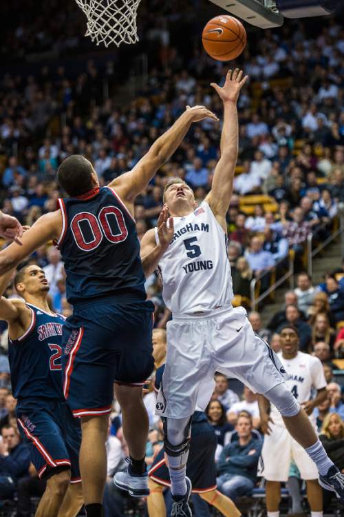 Chris Detrick  |  The Salt Lake Tribune
Brigham Young Cougars guard Kyle Collinsworth (5) shoots past St. Mary's Gaels forward Brad Waldow (0) during the game at the Marriott Center Thursday February 12, 2015.