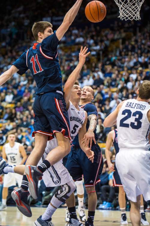 Chris Detrick  |  The Salt Lake Tribune
Brigham Young Cougars guard Kyle Collinsworth (5) shoots past St. Mary's Gaels forward Dane Pineau (11) and St. Mary's Gaels guard Kerry Carter (3) during the game at the Marriott Center Thursday February 12, 2015.